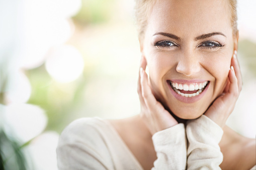 Women smiling after recieving dental treatment at Martin Periodontics 