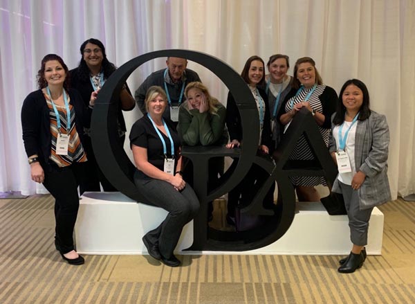 The team at Martin Periodontics gathered around a sculpture of the Ohio Dental Association logo