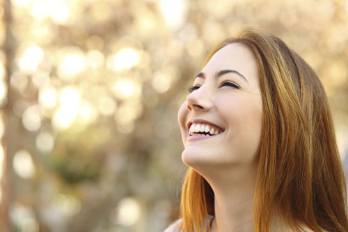 A woman smiling after oral pathology appointment at Martin Periodontics in Mason, OH