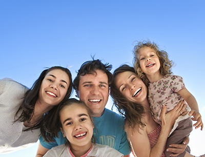 Family smiling about the dental services they received at Martin Periodontics in Mason, OH