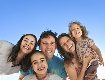 Family smiling about the dental services they received at Martin Periodontics in Mason, OH.