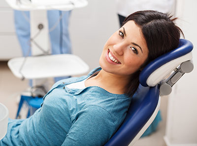 Smiling female patient in dental chair waiting for her LANAP treatment at Martin Periodontics in Mason and North Cincinnati, OH