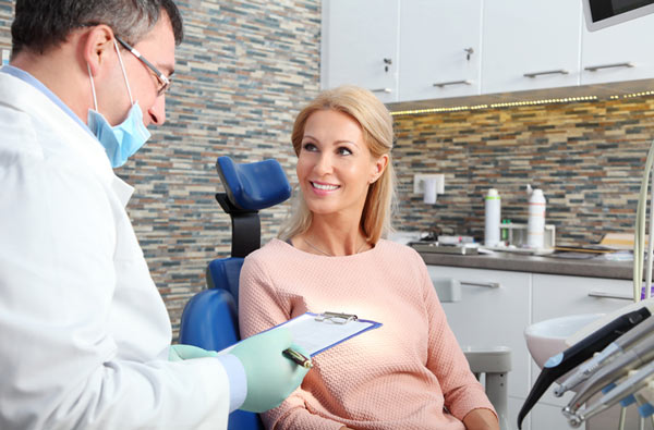 Woman talking to dentist at Martin Periodontics in Mason, OH 45040-7909