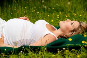 Blonde woman laying in grass